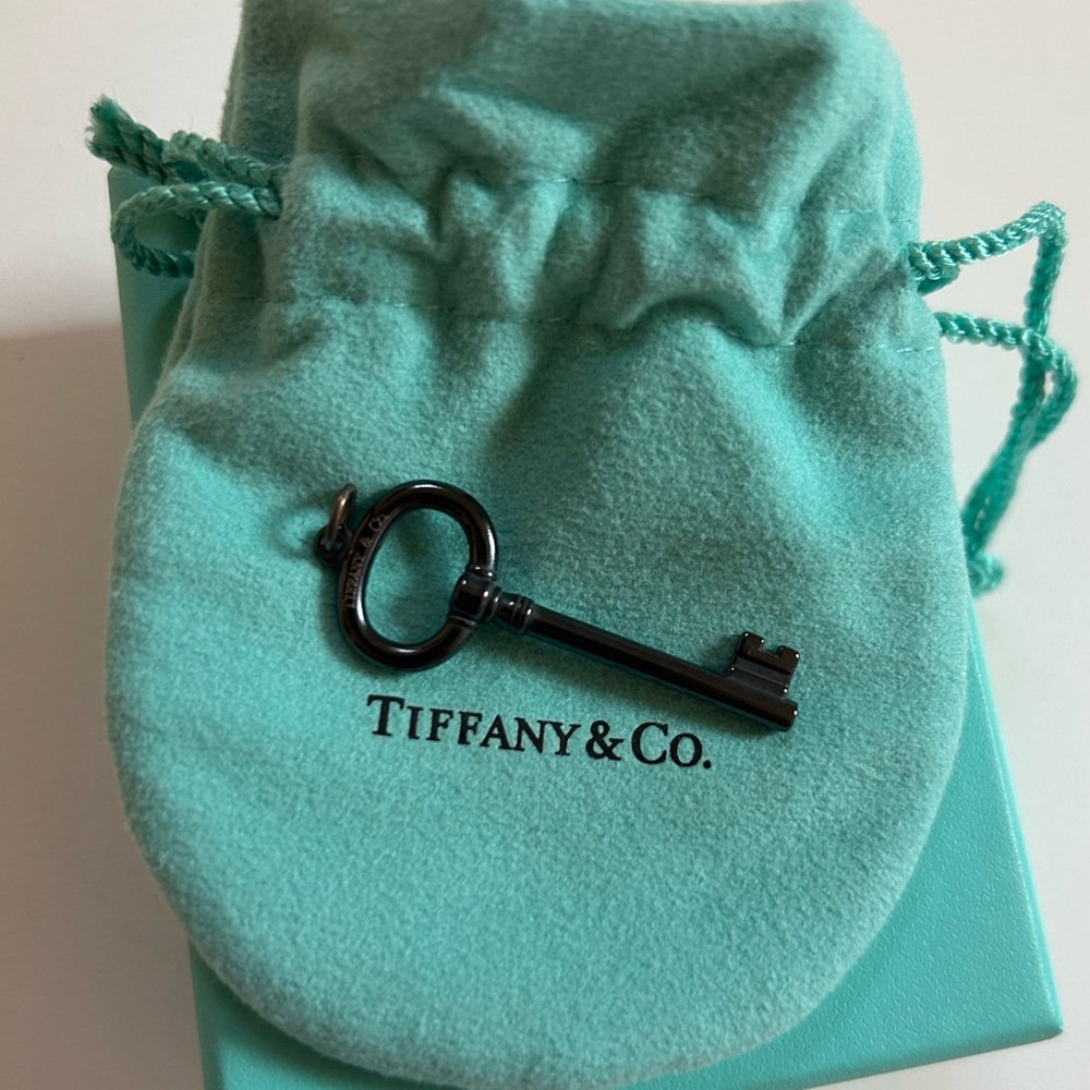 Tiffany and Co black key charm. NWT NEVER WORN
